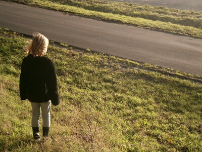 Girl standing near a road photo