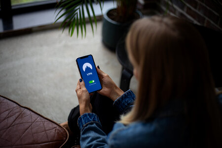 Woman holding a smartphone in the office photo