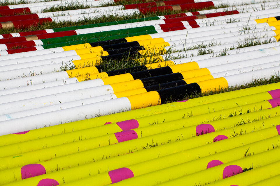 Coloured poles on grass