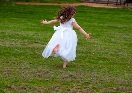 Bridesmaid running on grass photo
