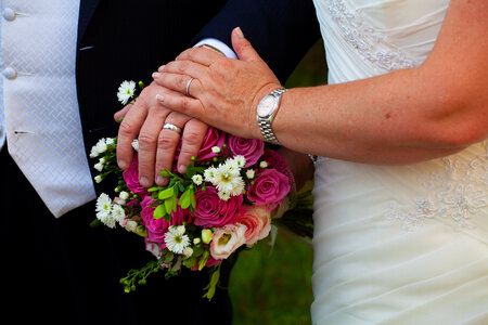 couple holding hands after being married photo