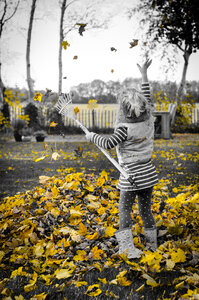 Kid playing with leaves photo