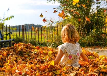 Girl playing with leaves photo