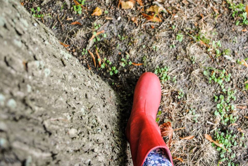 Child with red rubber boots