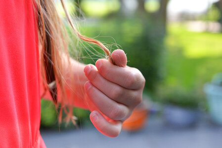 Girl playing with tangled hair photo
