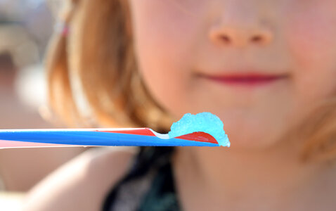 Girl drinking slush with a straw photo