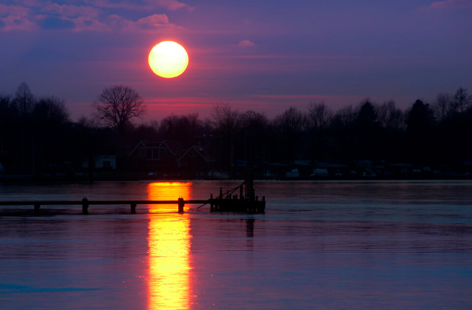Sunset at frozen lake photo