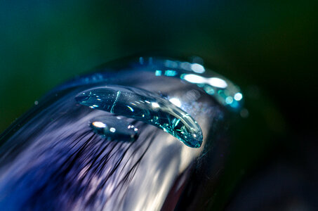 Water drop on faucet close up photo