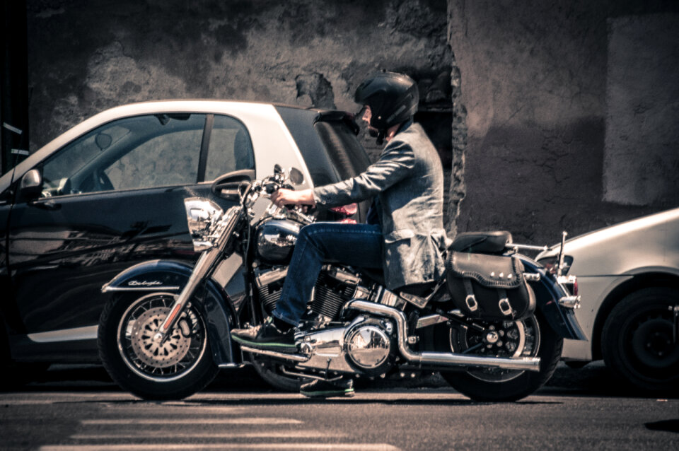 Man riding motorcycle in traffic photo