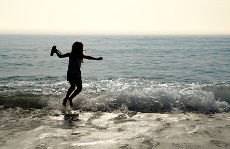 Girl jumping in the sea photo