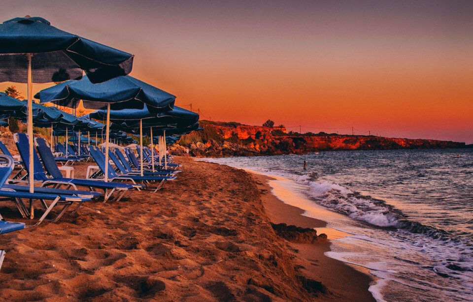 Sunset by the Sea with Umbrella and Sunbeds in Ammes Beach, Greek Island of Kefalonia photo
