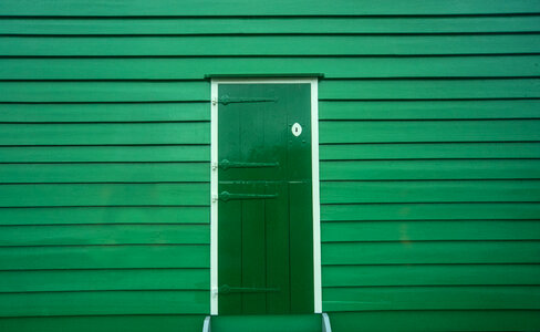 Green door of a wooden house photo