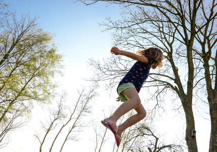 girl having fun on the trampoline photo