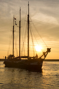 Sail boat at sunset photo