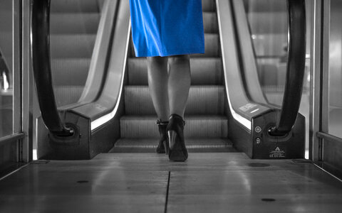 Woman approaching escalator photo
