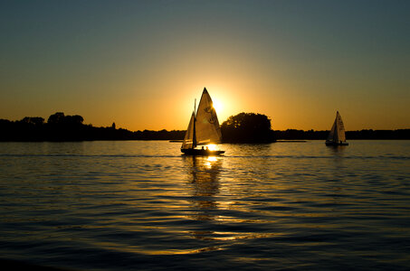 Sailing boats at sunset photo