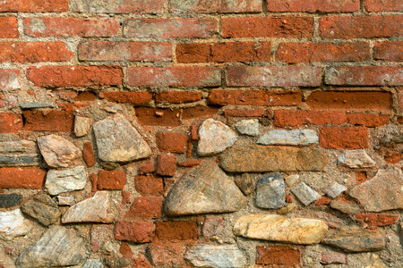 Texture of old wall from orange bricks and stones photo