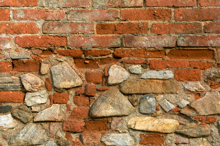 Texture of old wall from orange bricks and stones