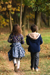 Boy and girl siblings in the woods photo