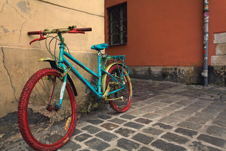 Old bright colored bicycle on the old street photo