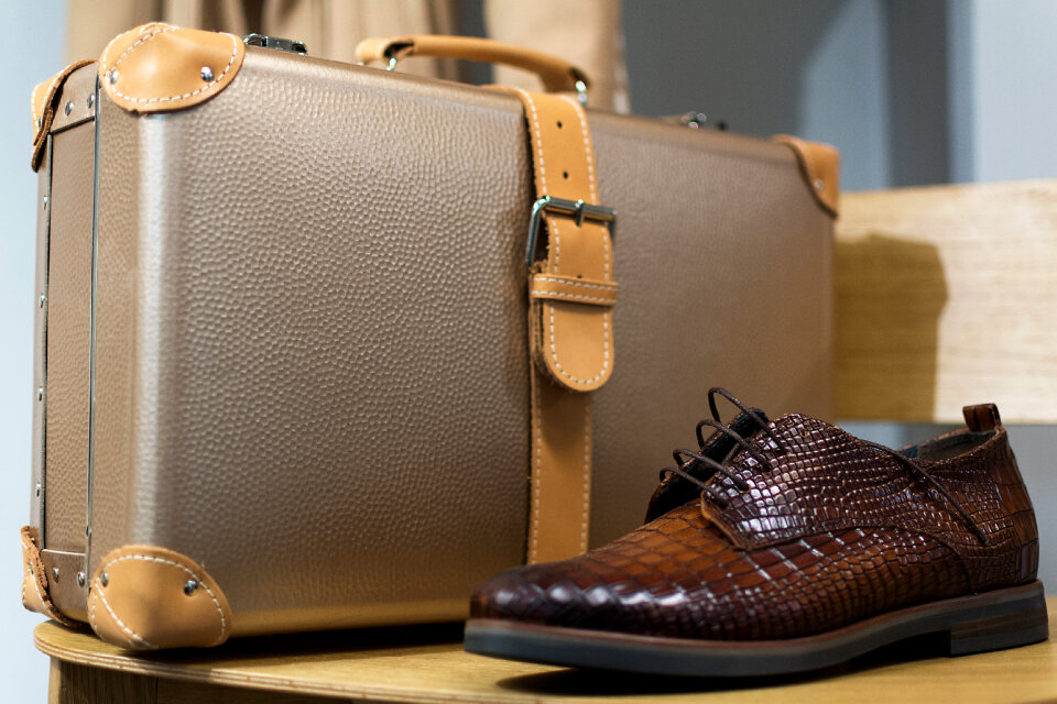 Men’s leather boots and suitcase