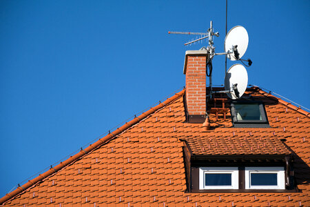 Satellite antenna dish on the roof photo