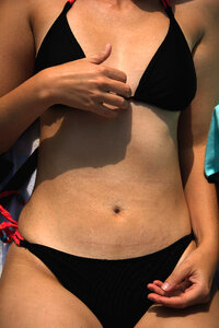 Detail of woman body in black bikini photo