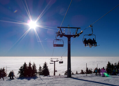 A chair lift at the top of a mountain on a sunny day photo