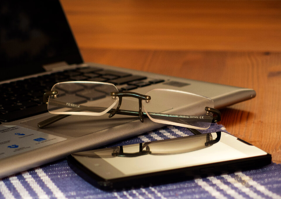 Glasses, Laptop And Phone On The Office Desk