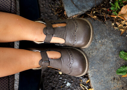 Legs and Shoes of a Little Baby in a Stroller photo