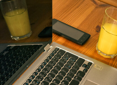 Laptop, Smartphone And Juice On The Wooden Table photo