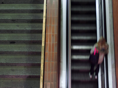 Woman On Moving Staircase