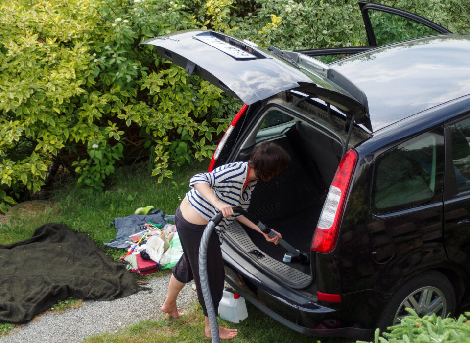 Woman cleaning her car