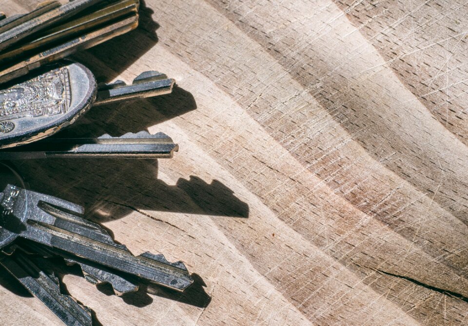 Bunch of keys on the wooden table.