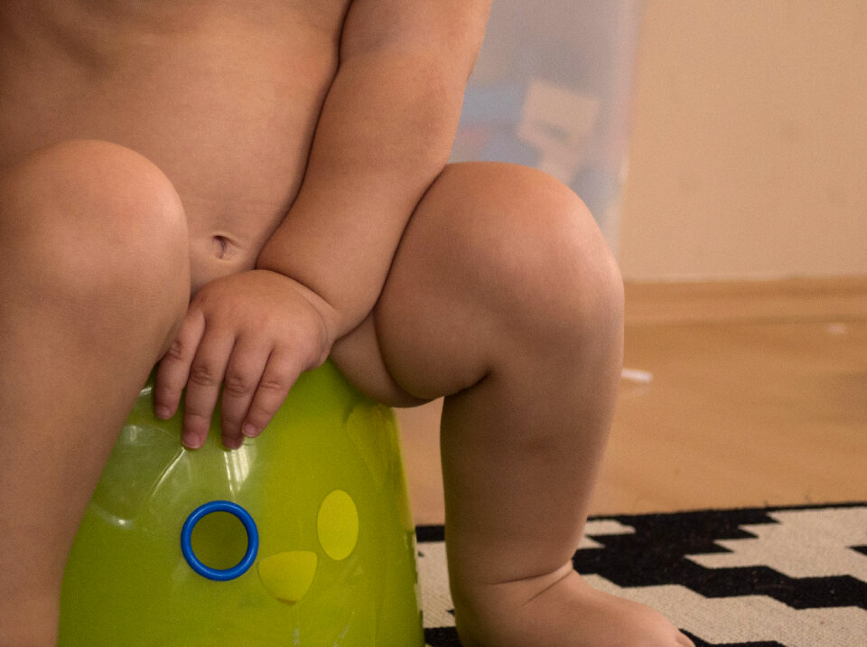 Baby sitting on potty