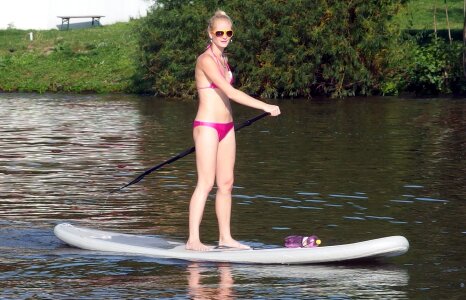 Woman Stands at Paddle Board photo
