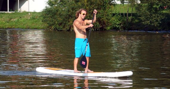 Man Stands at Paddle Board photo