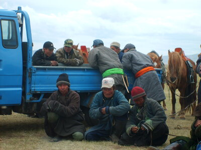 Mongolians on horse racing photo