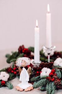 Christmas spruce decoration with candles and an angel photo