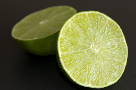 Lime halves on black background