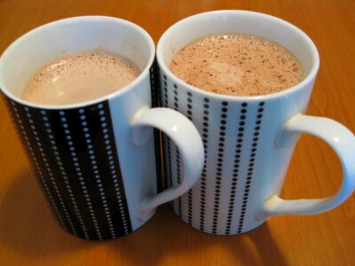 Pair of dotted mugs with chocolate photo