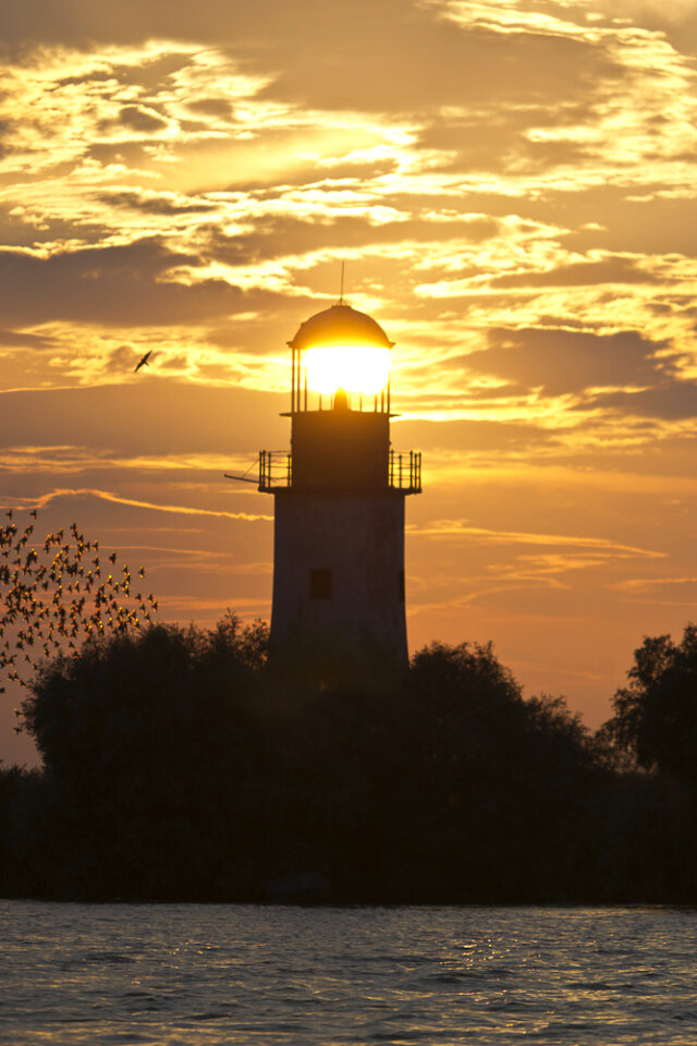 Lighthouse lit by setting sun