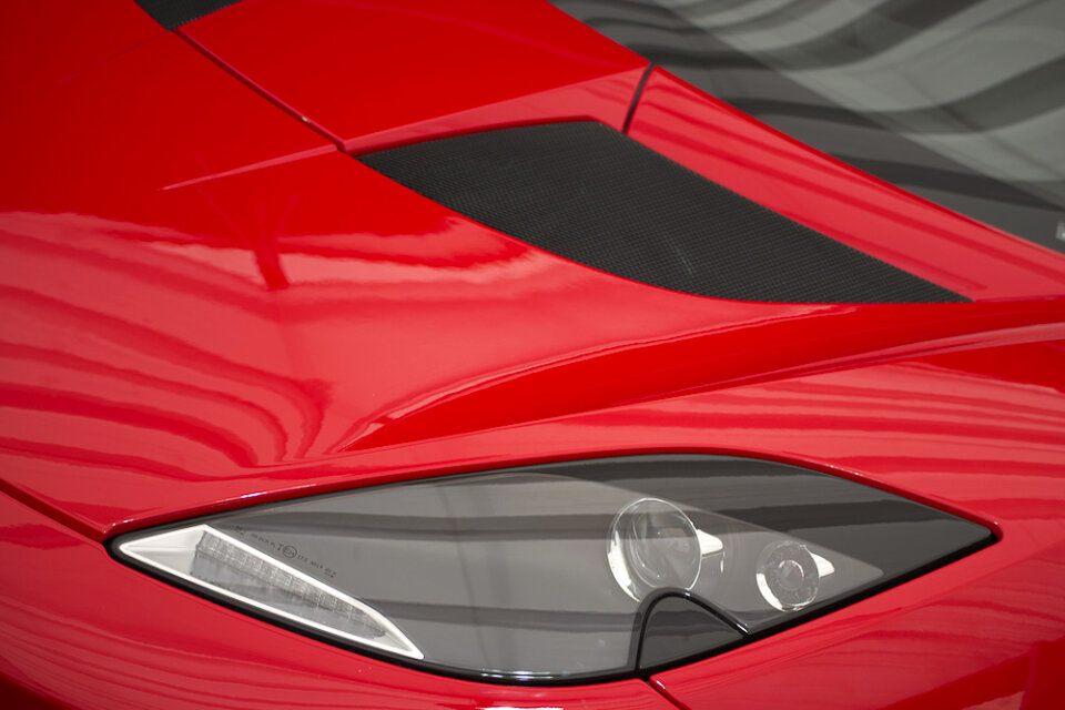 Headlight of a red sportscar