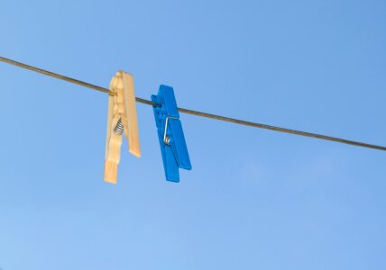 Blue and yellow pegs on clothes line photo