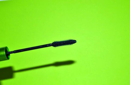 Mascara brush on green background