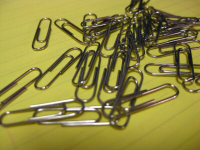 Paperclips on notebook file photo