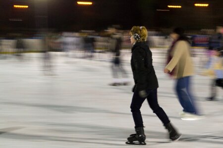 Woman gliding on ice at skating rink photo