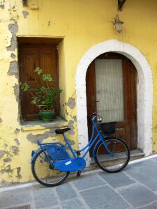 Blue bicycle leaning on wall photo
