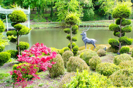 Statue of stag next to lake
