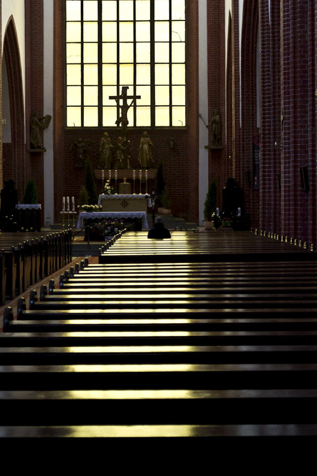 Lone man praying in cathedral photo